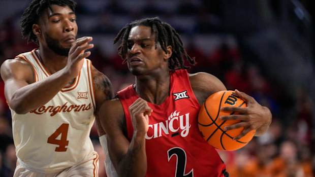 Cincinnati Bearcats guard Jizzle James (2) drives against Texas Longhorns guard Tyrese Hunter (4) in the second half of the NCAA Big 12 basketball game between the Cincinnati Bearcats and the Texas Longhorns at Fifth Third Arena in Cincinnati on Tuesday, Jan. 9, 2024. Texas pulled off a 74-73 win on a go-ahead basket in the final seconds of the game.